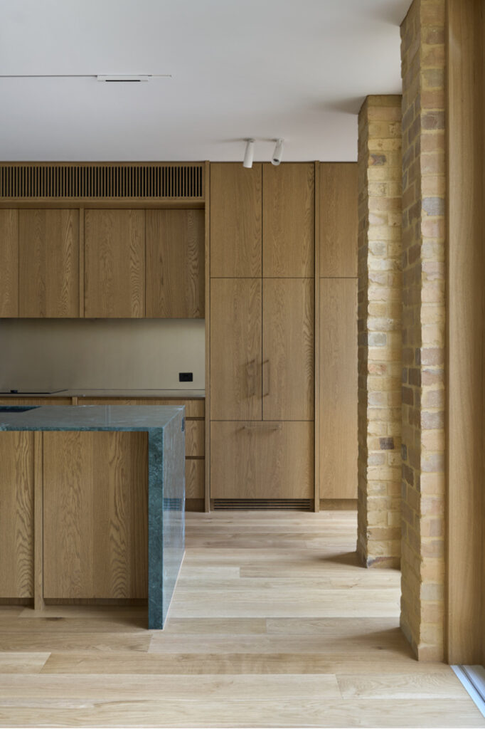 Oak joinery with stone benchtop to the kitchen.