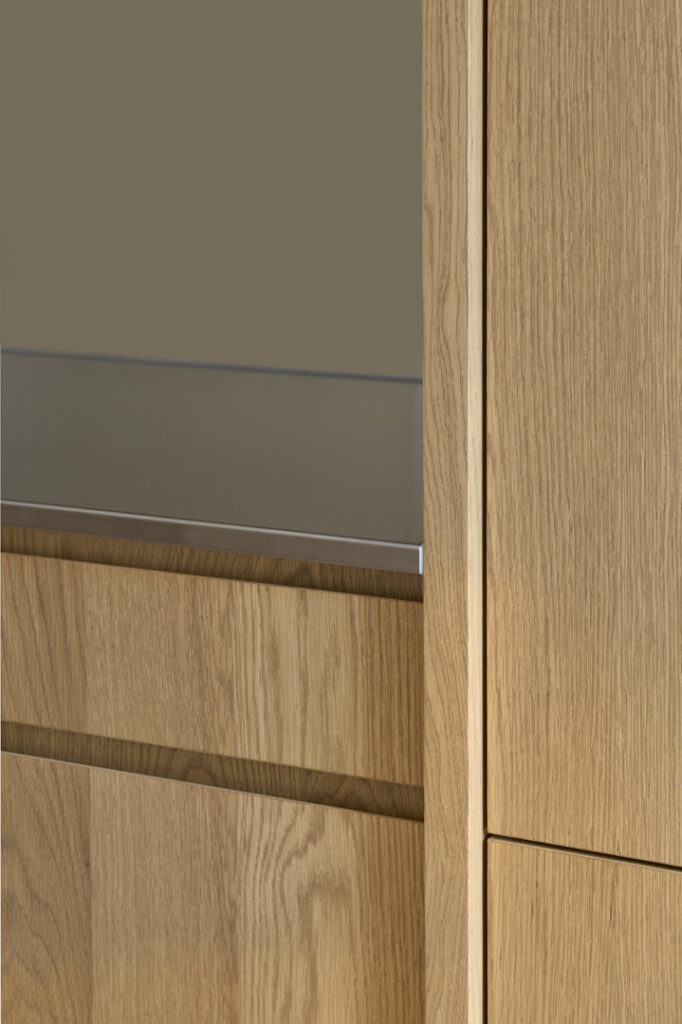 Detail of the oak joinery and stainless steel bench top to the kitchen.