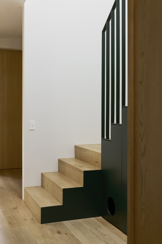 Timber stair and oak-lined hallway junction.