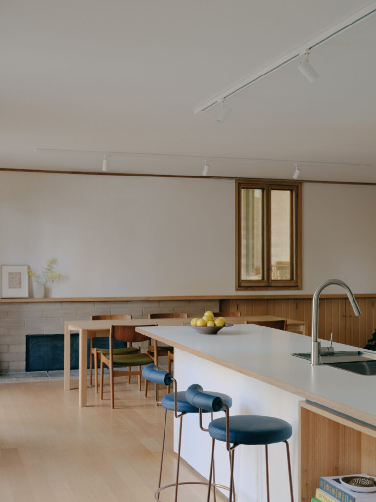 Contemporary kitchen island within restored modernist home in Ivanhoe.