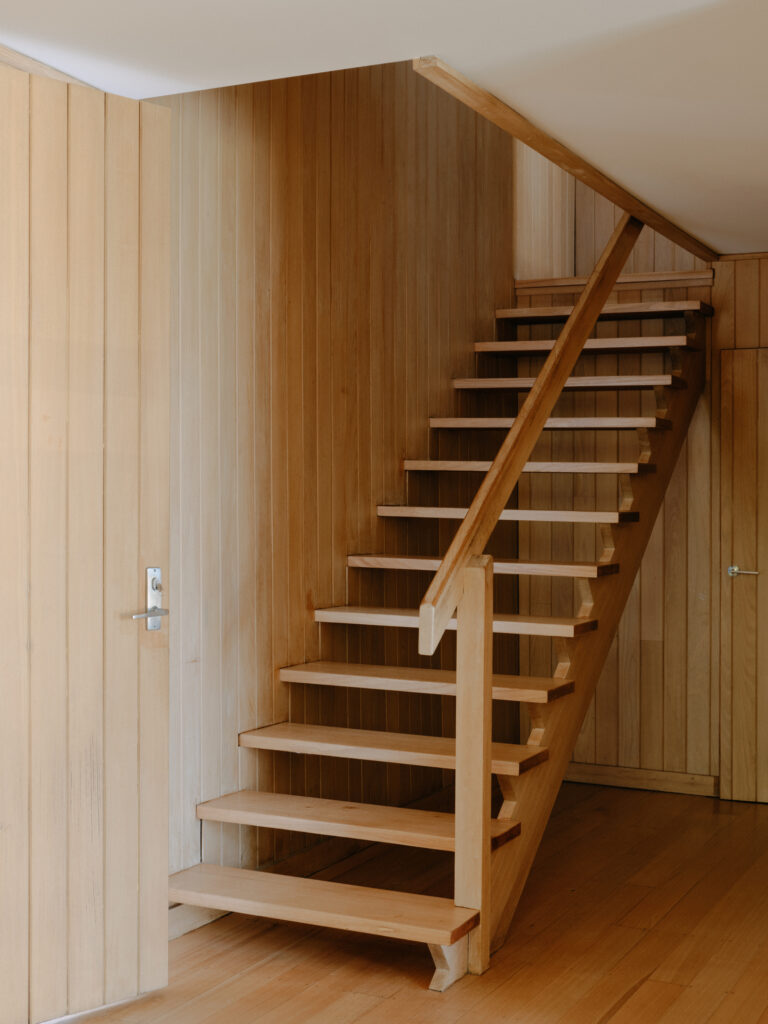 Original timber staircase with open risers in Ivanhoe mid-century modern renovation.